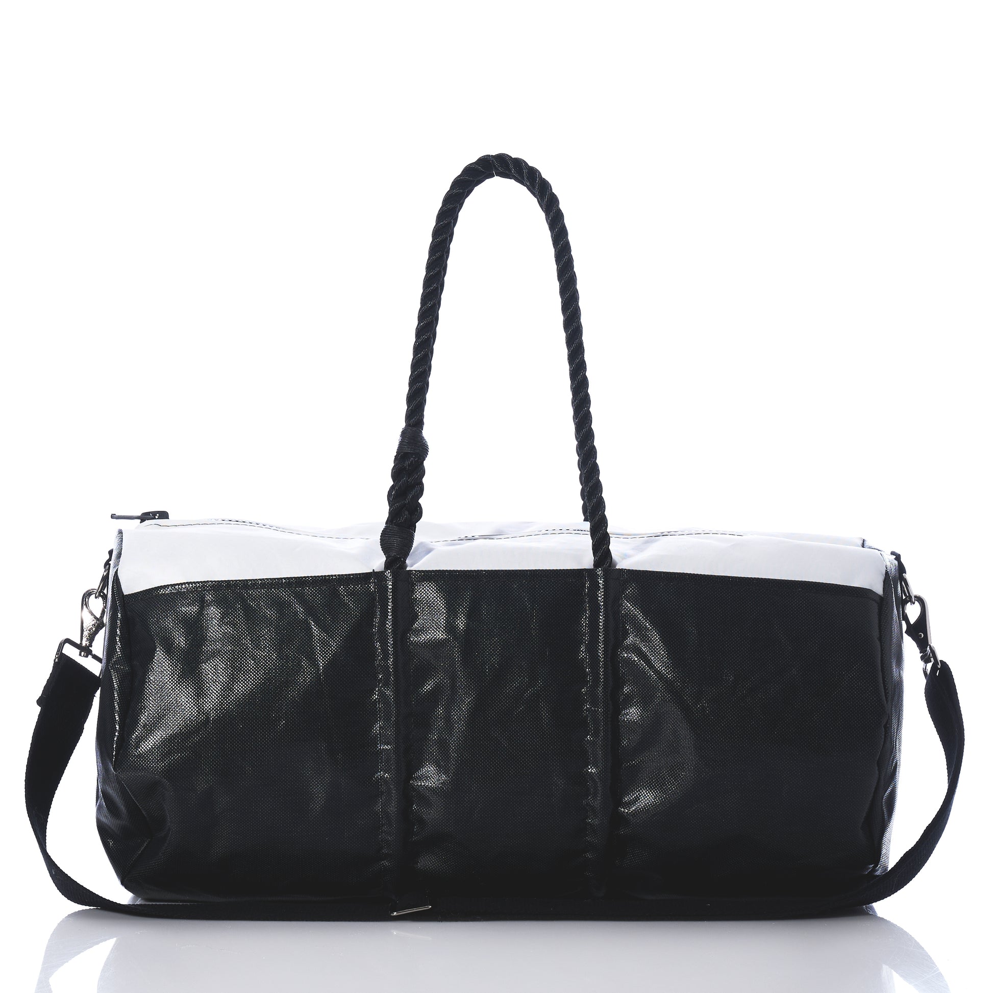 Introducing the Black Dragon Duffel by Sea Bags—a black and white travel duffel bag made from recycled sail cloth, designed with rope handles and a detachable shoulder strap. Shown on a reflective surface against a white background, this water-resistant bag combines style and durability, making it the perfect companion for your next adventure. by Sea Bags