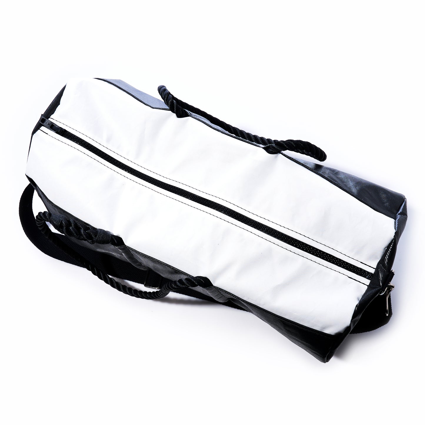 The Sea Bags Black Dragon Duffel, made from water-resistant recycled sail cloth and featuring a zipper closure with black carrying straps, is shown in black and white on a white background. by Sea Bags