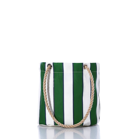 The Preppy Stripe Essential Handbag by Sea Bags, crafted from recycled sailcloth and featuring green and white vertical stripes with two rope handles, stands upright on a white reflective surface, showcasing its classic collegiate-inspired style. by Sea Bags