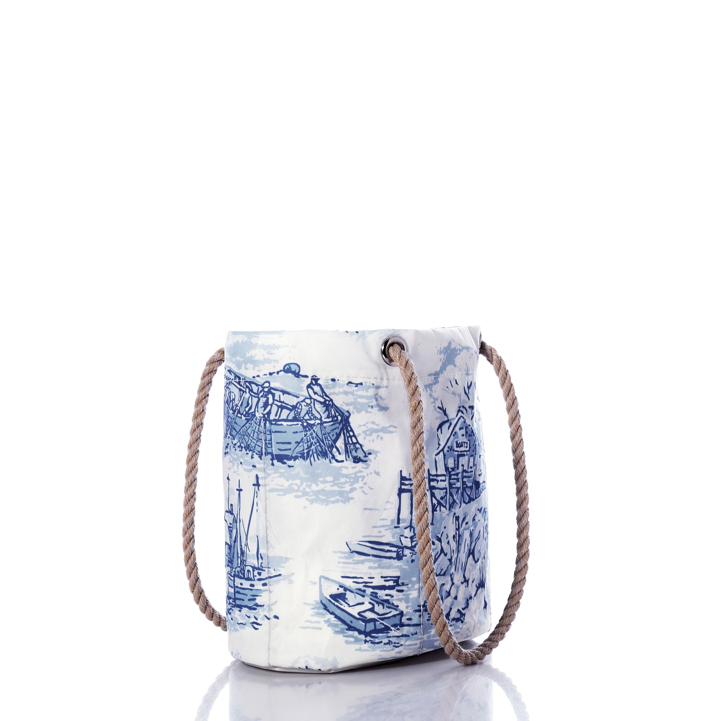 The Sea Bags Maine Fishing Village Essential Handbag features white and blue recycled sail cloth with Maine coast boat illustrations and sturdy brown rope handles, shown against a white background. by Sea Bags