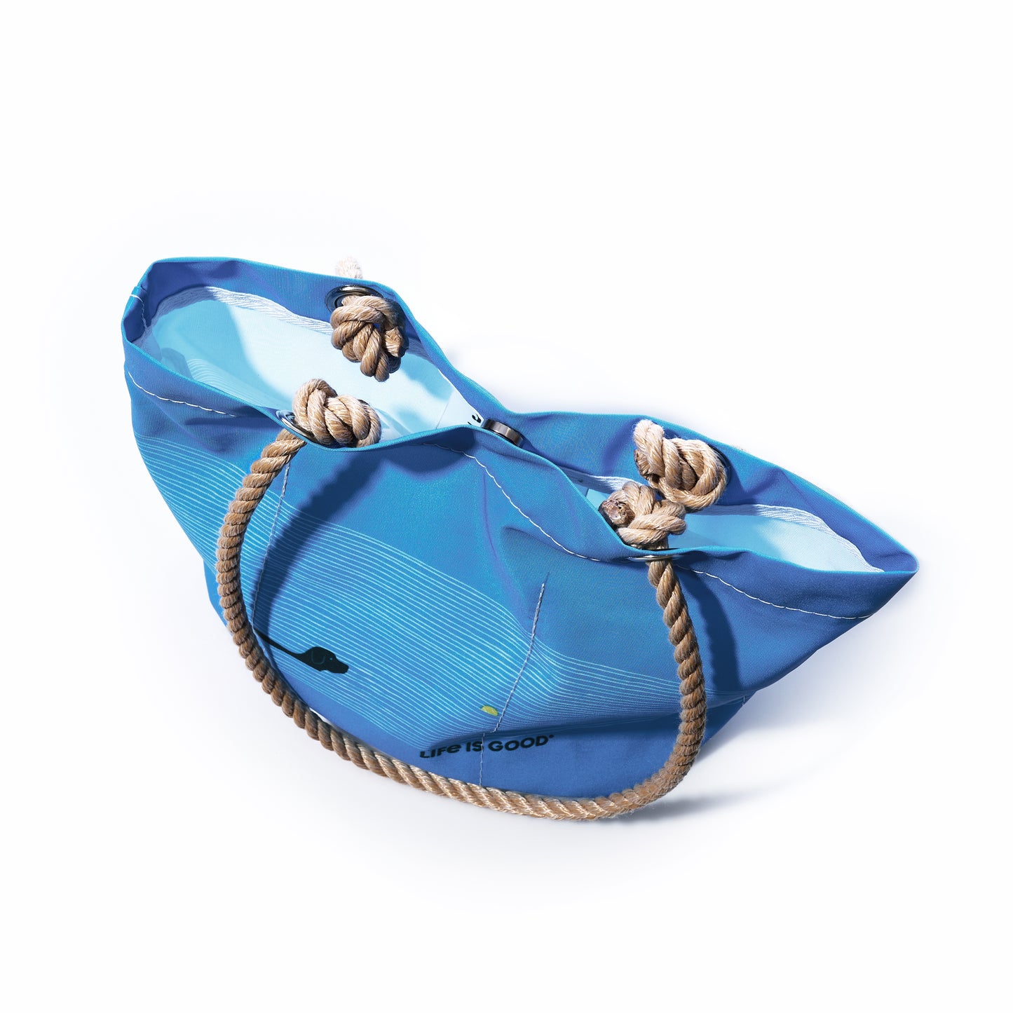 The Sea Bags Life is Good Dog Days Essential Handbag features durable rope handles and showcases a wave-inspired design along with the phrase Life is Good on the side. Photographed against a white background, this charming and inspirational bag is perfect for any outing. by Sea Bags