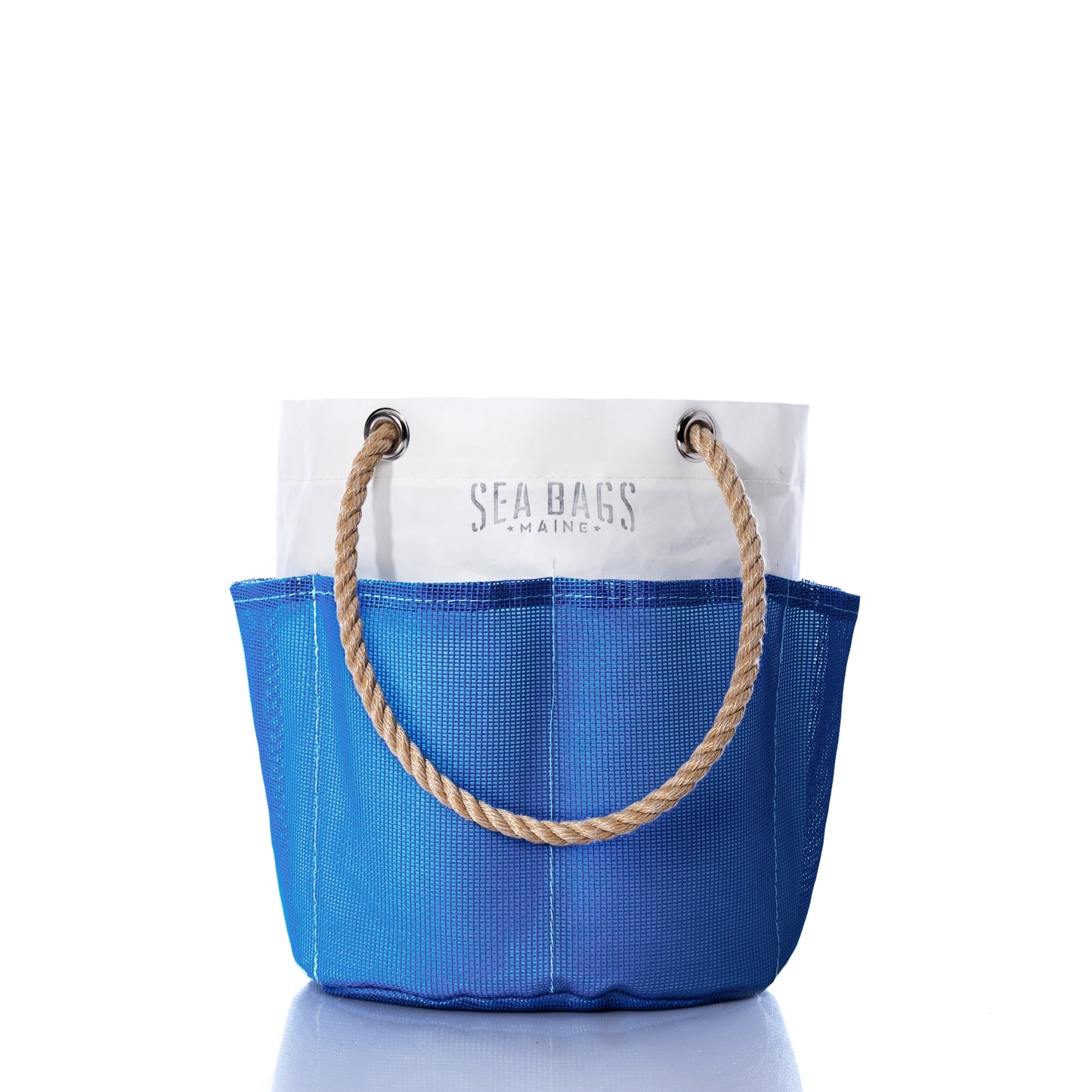 The Harbor Blue Gardeners Bucket Bag by Sea Bags features a blue and white design with rope handles, displaying the Sea Bags logo on the white section. Its durable mesh construction makes it perfect for carrying your gardening essentials or using as a stylish gardener’s bucket. by Sea Bags