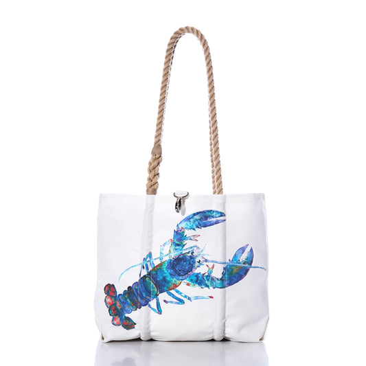 The Sea Bags Multicolor Lobster Handbag is crafted from recycled sail cloth and features a vibrant blue lobster illustration inspired by a Maine artist, two tan rope handles, and is photographed on a white background. by Sea Bags