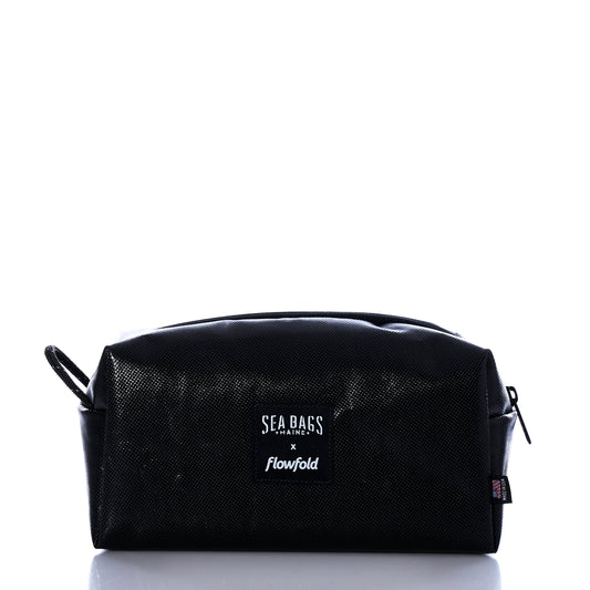 A Black Dragon Toiletry Bag by Sea Bags, featuring a water-resistant zippered design and branded label on the front, photographed against a white background. by Sea Bags