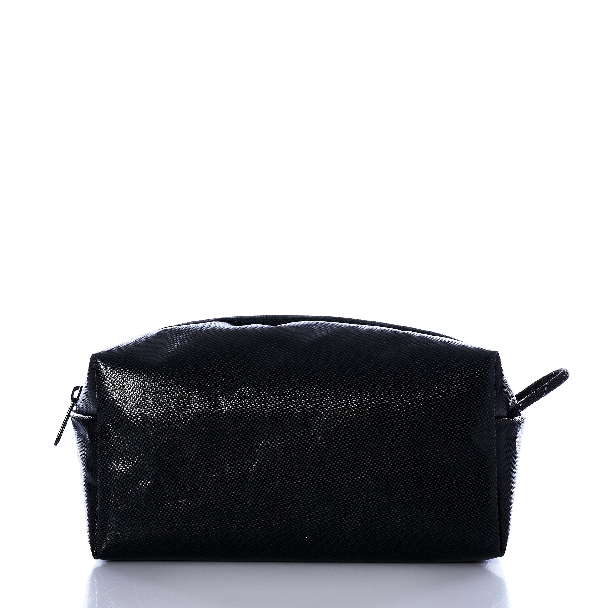 The Sea Bags Black Dragon Toiletry Bag is a rectangular, water-resistant toiletry kit featuring a textured black surface, a zippered closure, and a small side handle, shown here against a white background. by Sea Bags