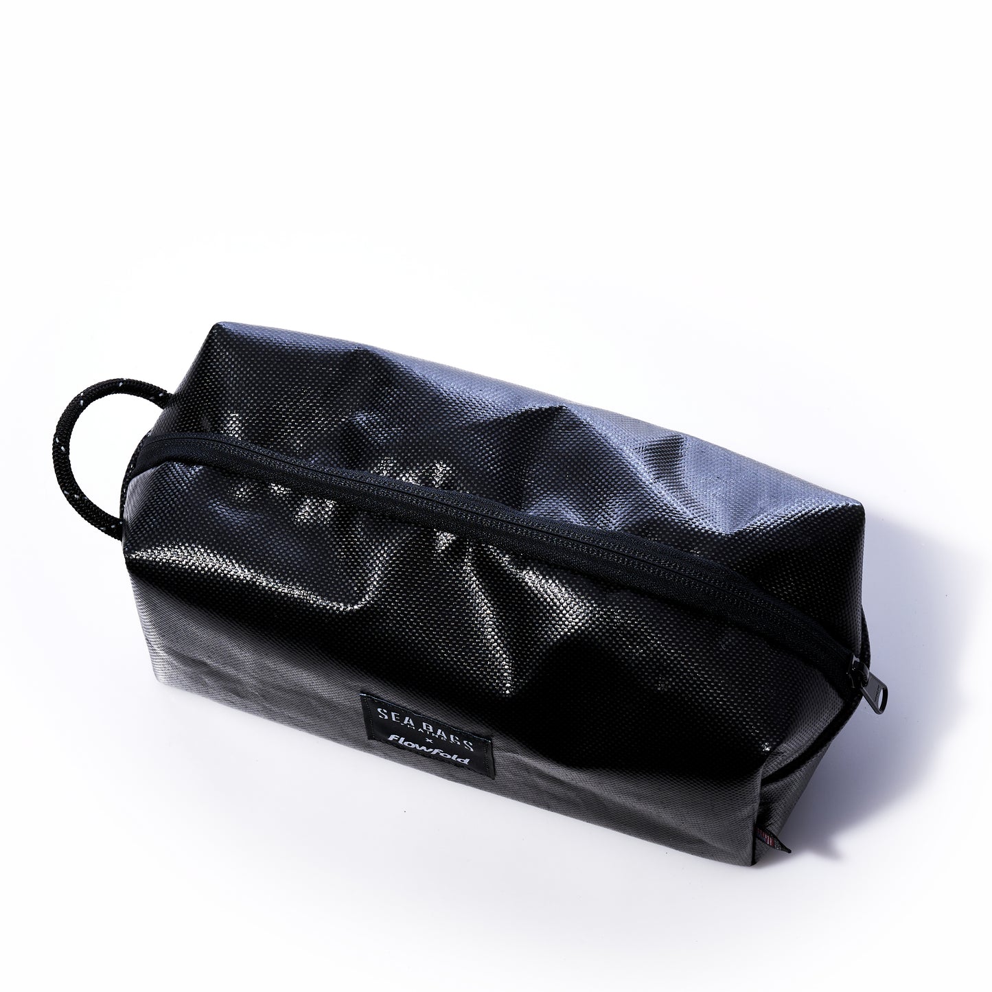 Introducing the Sea Bags Black Dragon Toiletry Bag—a durable, water-resistant kit featuring a convenient handle on one end and showcased against a white background. This practical and stylish accessory is perfect for travelers or anyone on the go, making it an exceptional and unique gift option. by Sea Bags