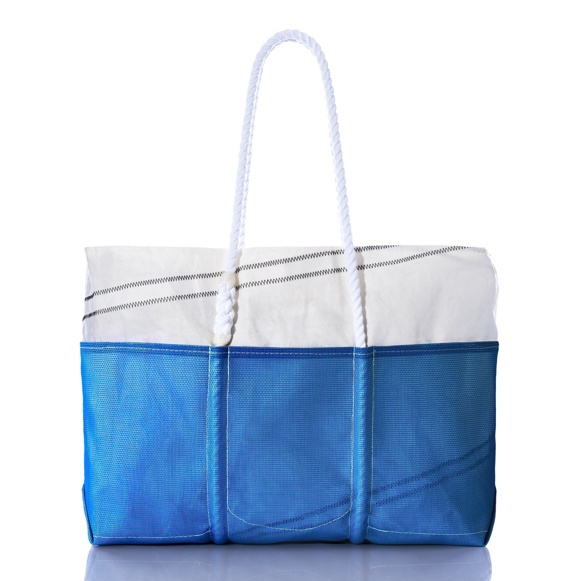 Sea Bags Harbor Blue Beachcomber Tote, crafted from recycled sails in blue and white with white rope handles and visible stitching, is photographed against a white background. by Sea Bags