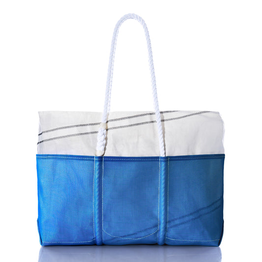 Sea Bags Harbor Blue Beachcomber Tote, crafted from recycled sails in blue and white with white rope handles and visible stitching, is photographed against a white background. by Sea Bags