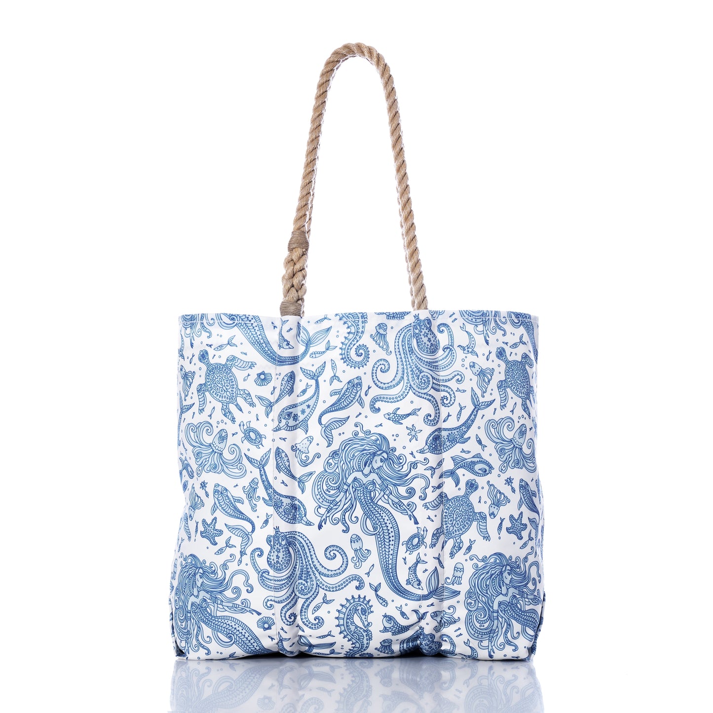 Paisley Mermaid Medium Tote by Sea Bags—a white tote bag adorned with blue, ocean-inspired paisley mermaid, fish, and seashell illustrations. Features two twisted rope handles for a nautical beach bag look. Photographed on a white background with a subtle reflection. by Sea Bags