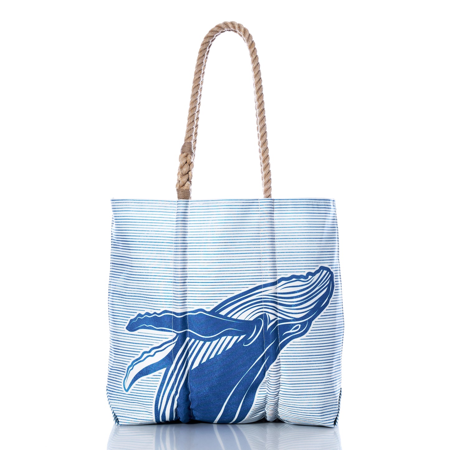 The Whale Watch Medium Tote by Sea Bags is handcrafted in Maine from recycled sailcloth and features blue and white stripes, a blue whale illustration on the front, sturdy rope handles, and is photographed on a white background. by Sea Bags