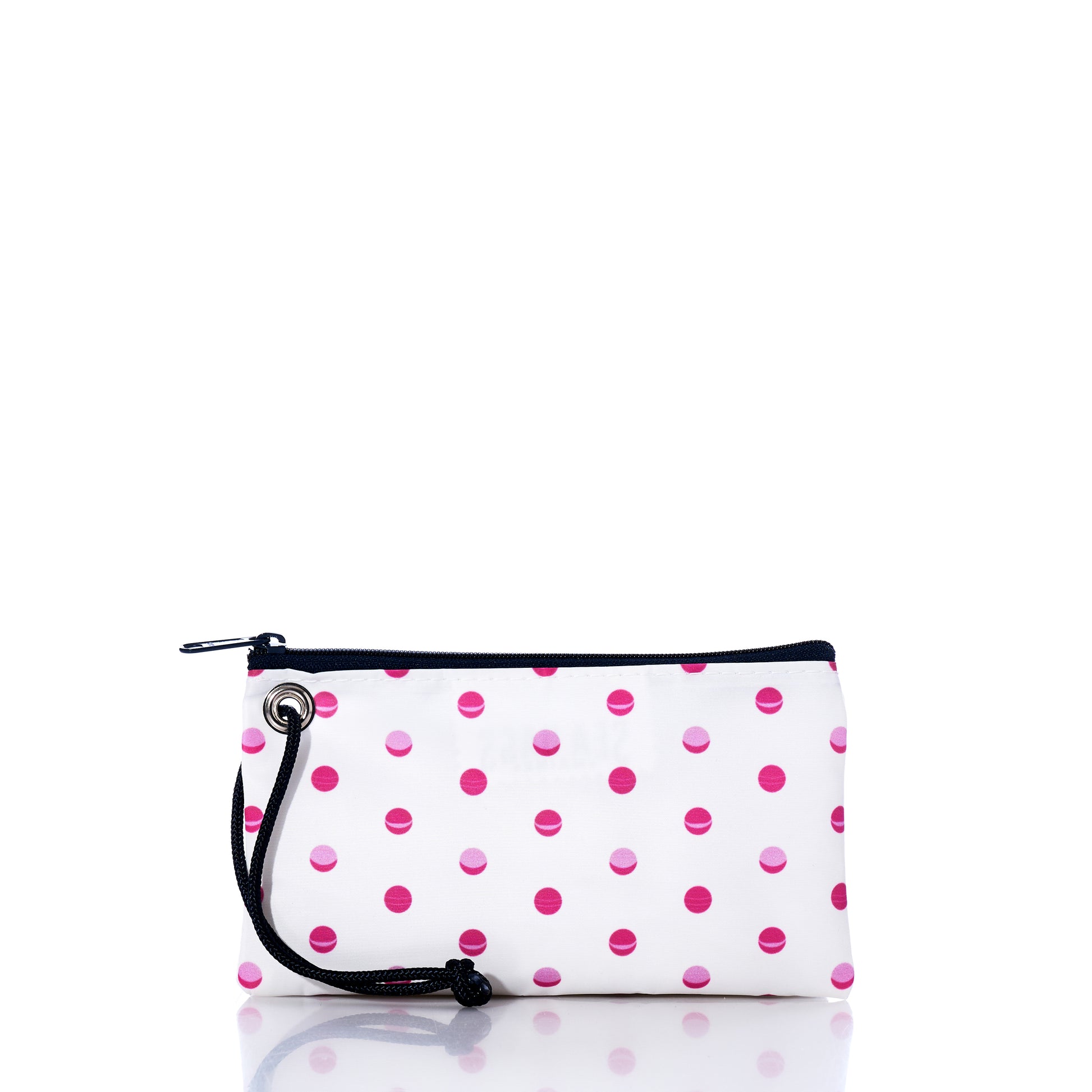 The Sea Bags Flip Side Summer Dots Wristlet is a white rectangular pouch adorned with playful pink and red polka dots. It features a secure zippered closure and a black cord wrist strap attached to a metal grommet on the side, making it a stylish and practical travel accessory. The pouch is shown isolated on a white background. by Sea Bags