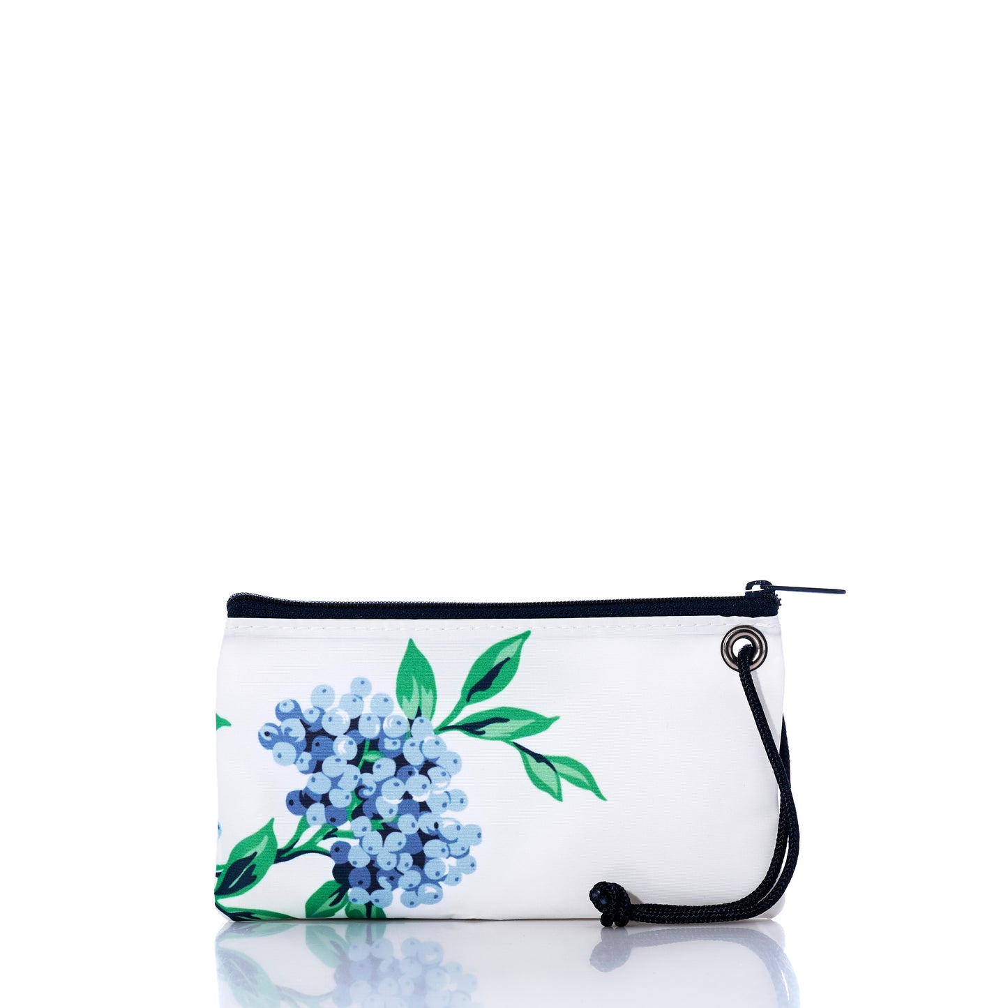 The Blueberry Print Wristlet by Sea Bags features a blue and green floral design inspired by Maine wild blueberries, crafted from recycled sail cloth. This white zippered pouch includes a black wrist strap and a metal grommet on one side, and is displayed on a reflective white surface. by Sea Bags