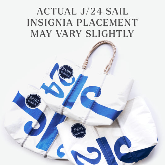 Three white Sea Bags Race Day Vintage J24 Large Totes, each featuring blue sail numbers and sturdy rope handles, are displayed. The text above notes, “Actual J/24 sail insignia placement may vary slightly.” Each tote is handcrafted from recycled sails, making every bag a unique piece inspired by the J/24 sailboats used by the Sea Bags Sailing Team. by Sea Bags