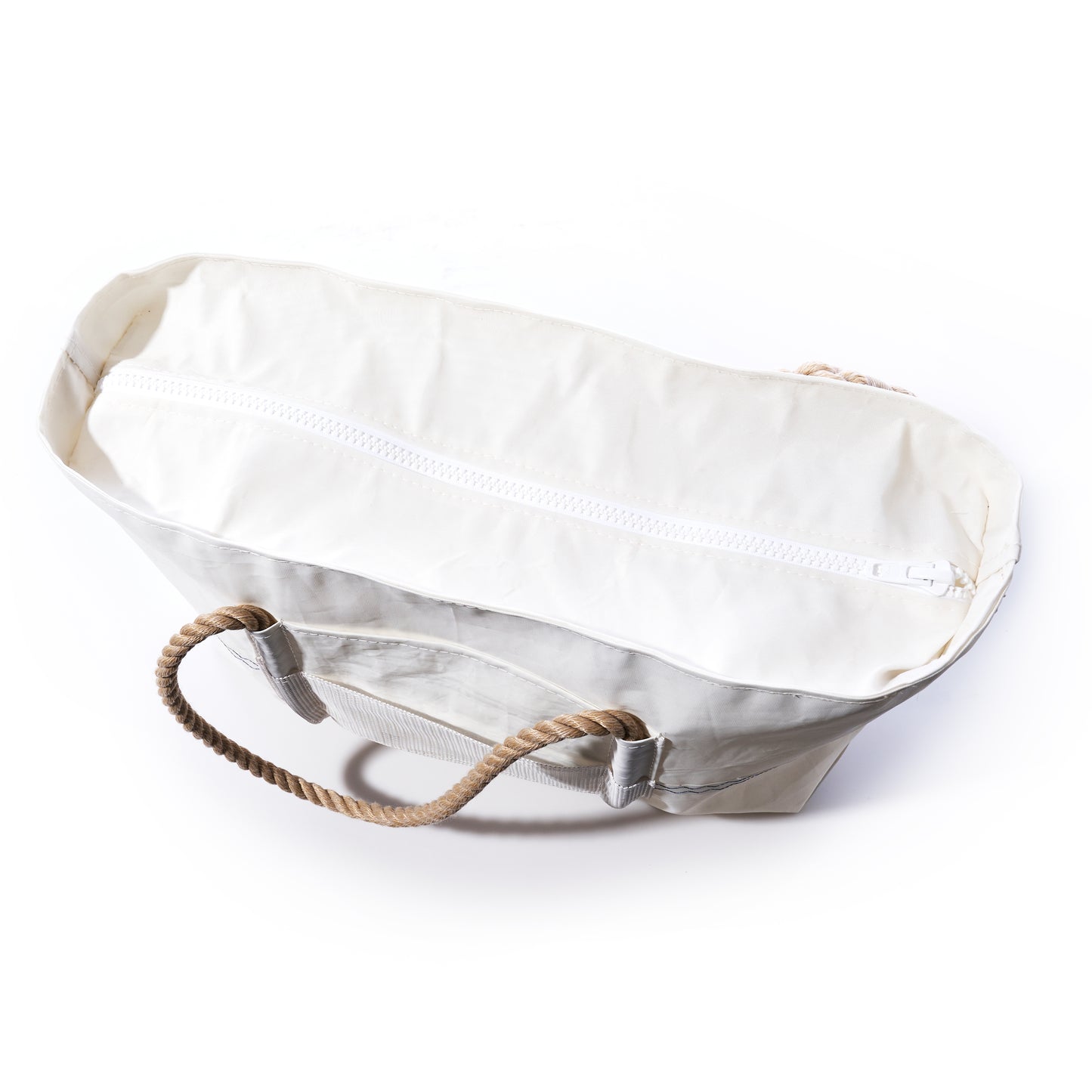 The Sea Bags Trolley Sleeve Travel Tote, crafted from recycled sailcloth, features a white canvas design with tan rope handles and a white zipper. Shown on a white background, this tote offers added convenience with its mesh trolley sleeve. by Sea Bags
