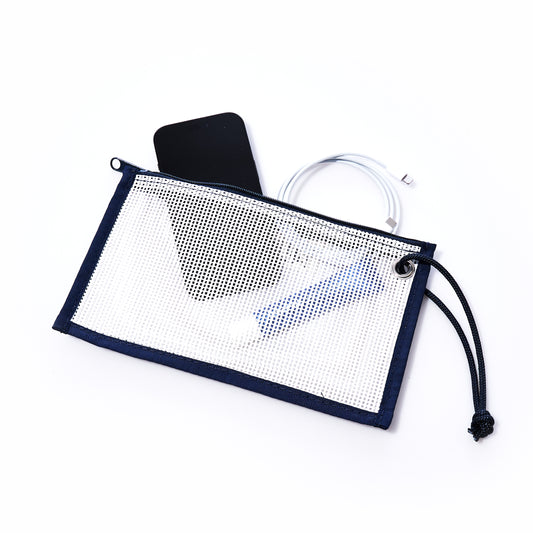 A Sea Bags Mesh Tote Organizer Pouch containing a black smartphone, a coiled charging cable, and a cylindrical object is displayed on a white background. by Sea Bags