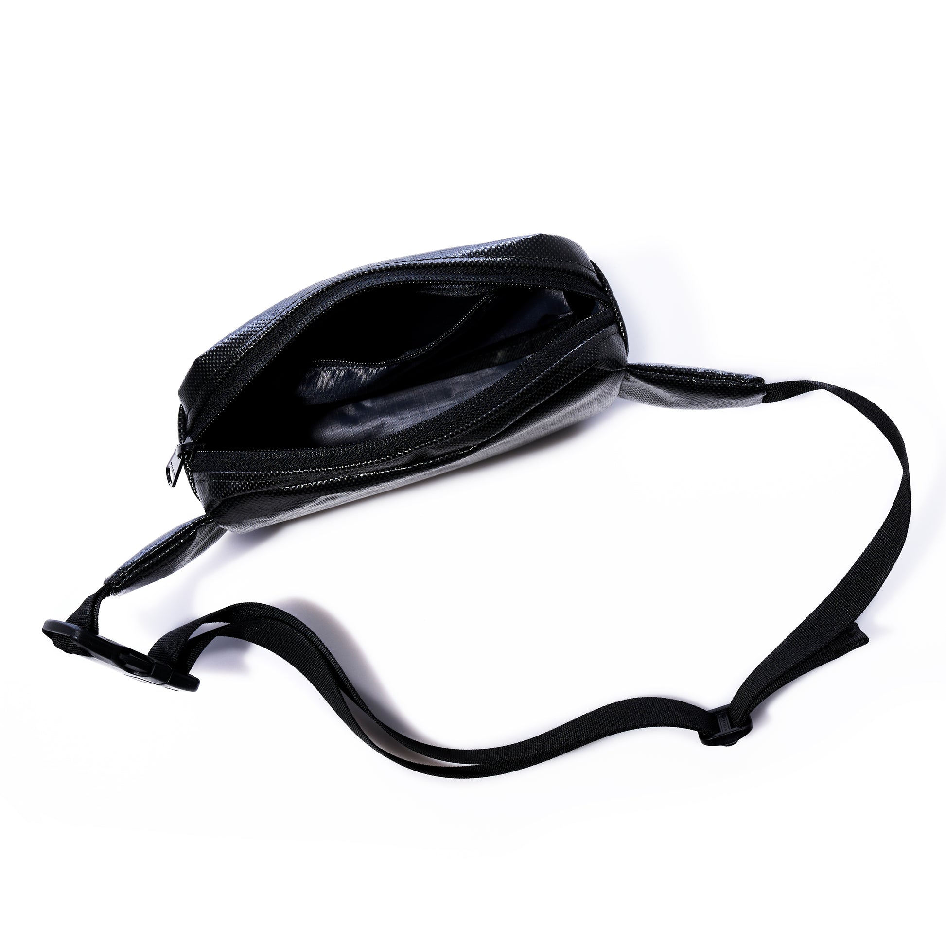 The Sea Bags Black Dragon Belt Bag is shown with its adjustable strap, unzipped to reveal the empty main compartment against a white background. Crafted from water-resistant material, this versatile crossbody bag makes a practical and unique gift for anyone on the go. by Sea Bags