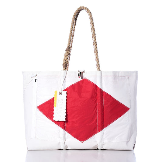 Sea Bags Foxtrot Signal Flag Large Tote: A white tote bag crafted from recycled sail cloth, featuring a bold red diamond patch at the center inspired by maritime signal flags, finished with durable rope handles and a signature white tag attached to one handle. by Sea Bags