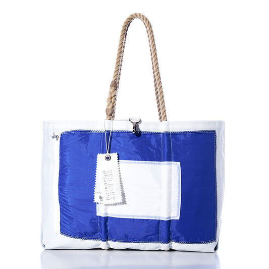 The Sea Bags Papa Signal Flag Large Tote is a handcrafted tote bag with a blue and white design inspired by maritime signal flags, featuring sturdy rope handles, a front pocket, and an attached white tag. by Sea Bags