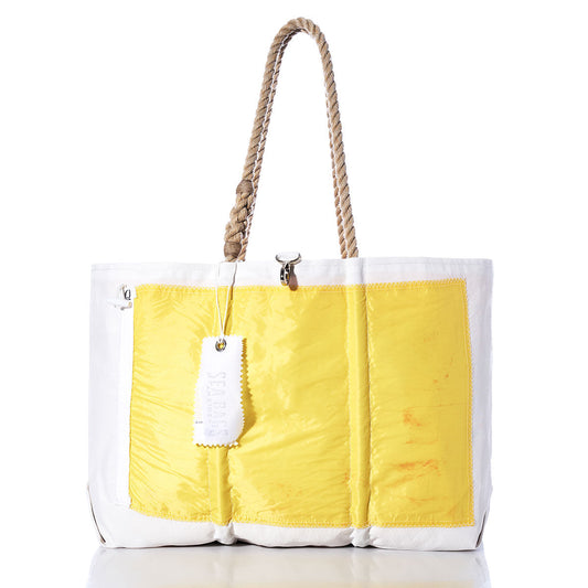 The Sea Bags Quebec Signal Flag Large Tote features a spacious white design with a yellow front panel, sturdy rope handles, and a signature white tag, all crafted from recycled sail cloth for a classic nautical style. by Sea Bags