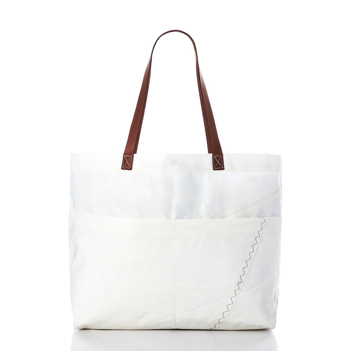 Sea Bags’ Large Market Tote, crafted from white recycled sail with brown leather handles, features an exterior pocket and visible zigzag stitching detail, shown against a plain white background. by Sea Bags