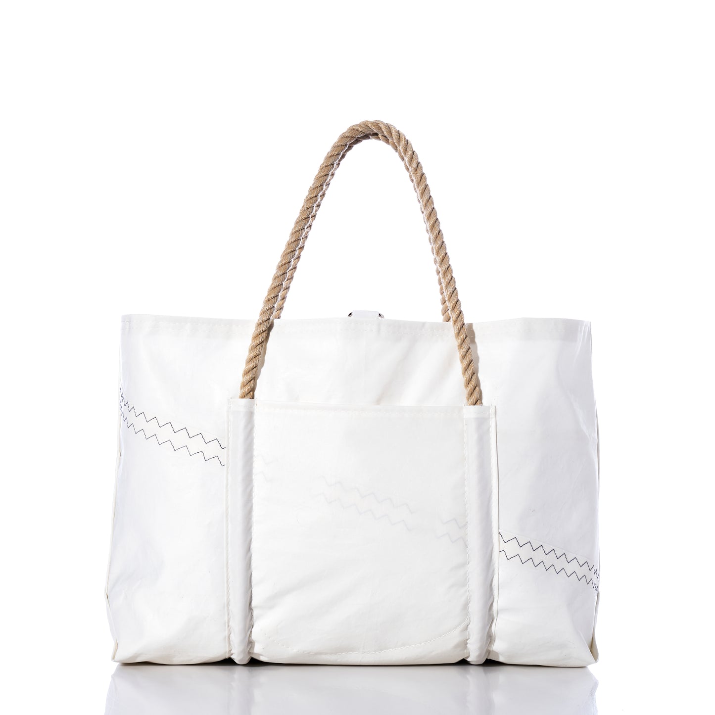 The U.S. Yacht Ensign Wharf Tote by Sea Bags is a large white canvas bag with rope handles, zigzag stitching details, and an exterior front pocket, photographed against a white background. Inspired by nautical style and crafted from recycled sail cloth, this tote showcases sustainable craftsmanship in every detail. by Sea Bags