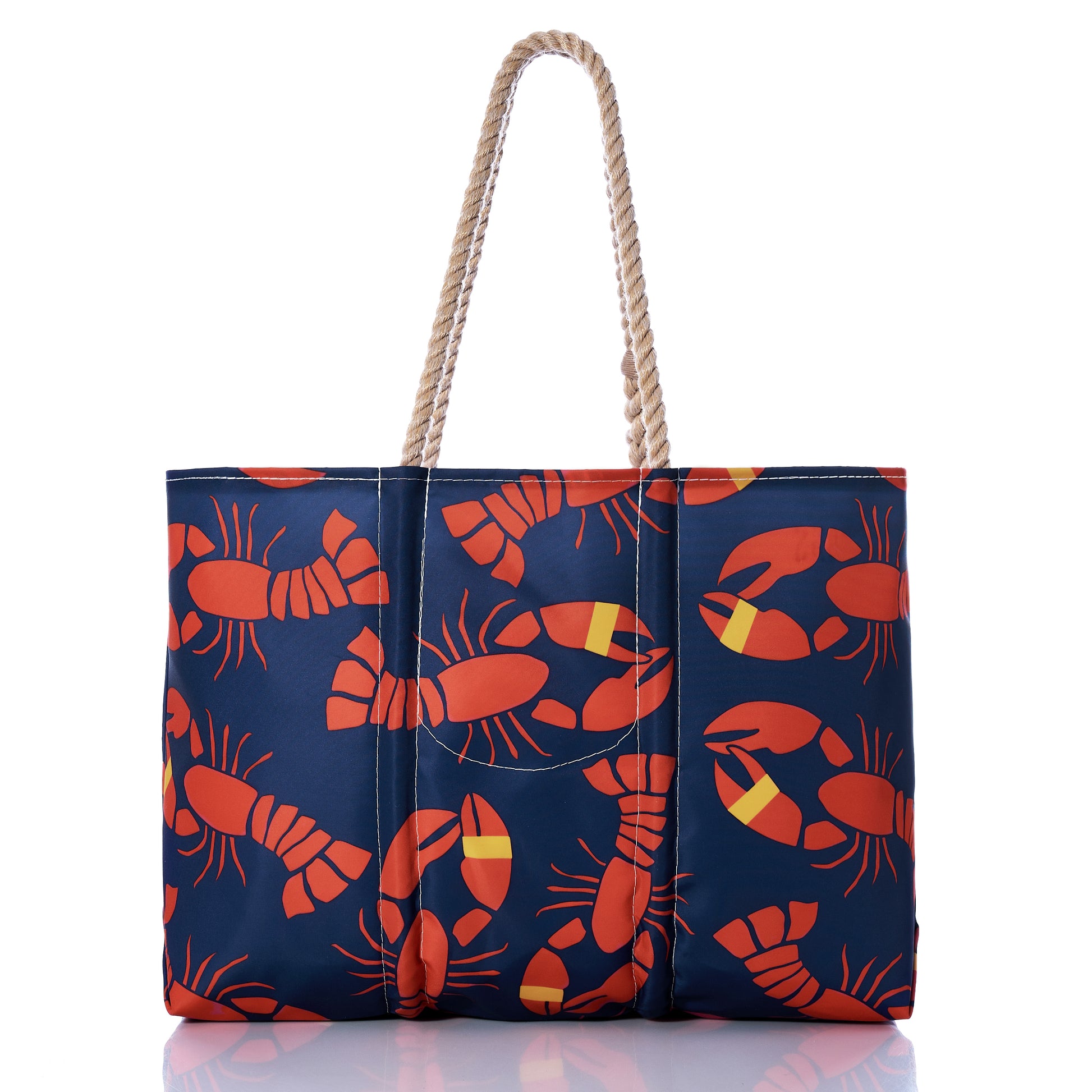 The Sea Bags Lobster Bake Large Tote, crafted from recycled sail cloth, features eye-catching red lobster prints and durable rope handles. Displayed against a white background with a subtle reflection, it offers a timeless maritime tote look. by Sea Bags