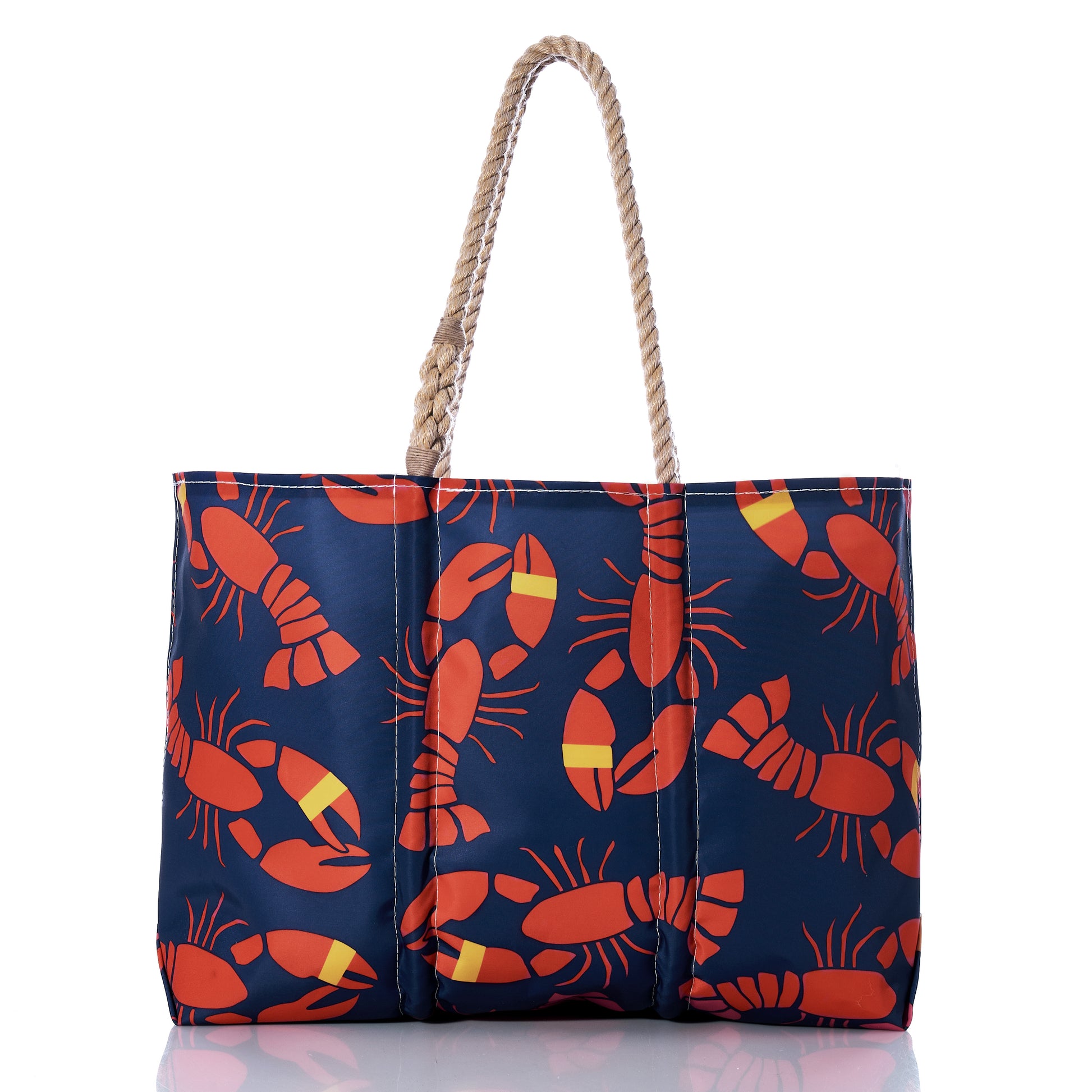 Introducing the Sea Bags Lobster Bake Large Tote: a navy blue maritime tote made from recycled sail cloth, adorned with red lobsters and yellow-striped lobster claws in a repeating pattern, and finished with classic rope handles—an ideal companion for any coastal adventure. by Sea Bags