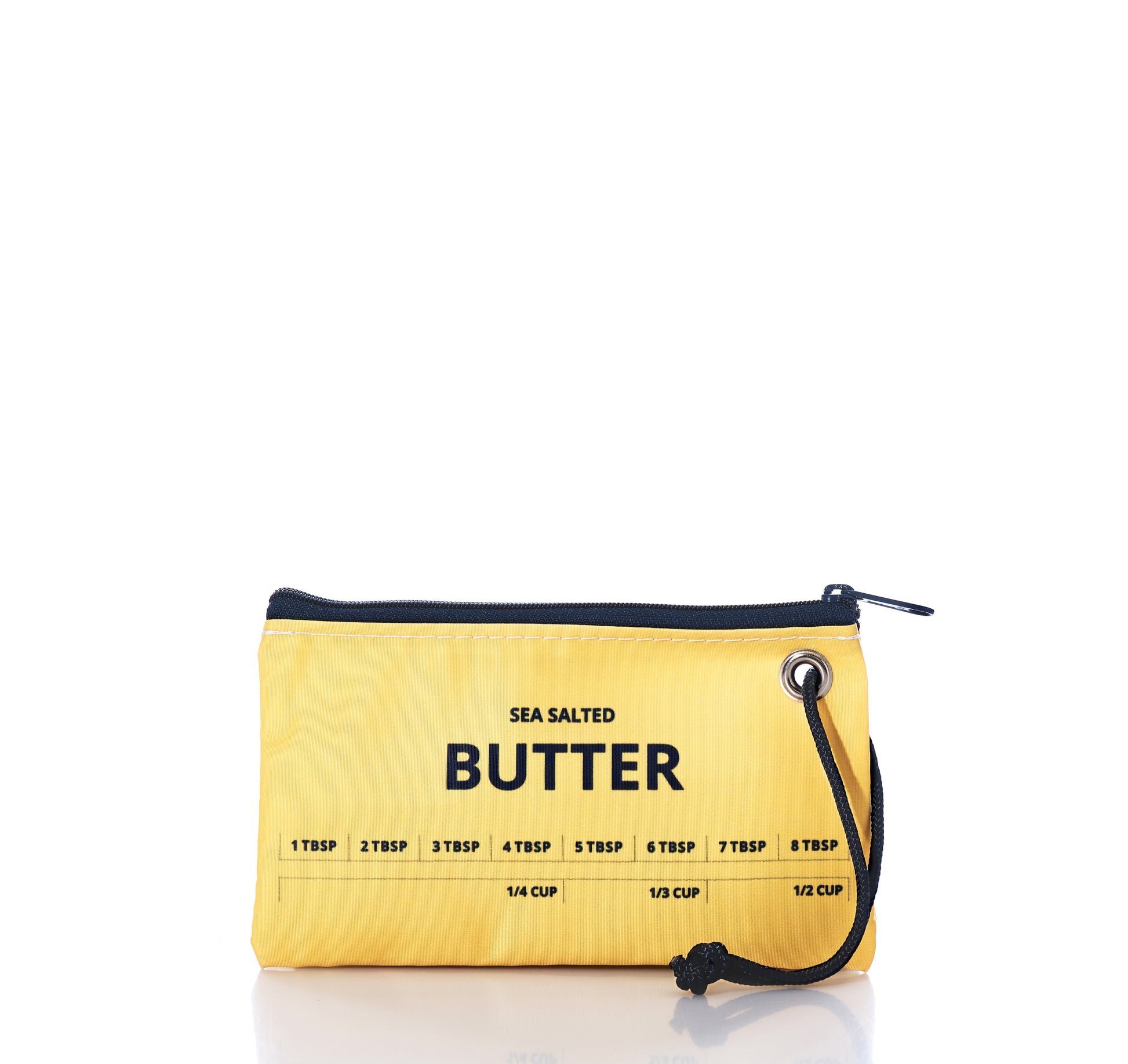 Introducing the Butter Wristlet by Sea Bags—a compact yellow zippered pouch crafted from recycled sail cloth, bringing a hint of coastal charm. Labeled Sea Salted Butter and featuring tablespoon and cup measurements printed on the front, this versatile accessory is perfect for carrying your essentials or even a stick of melted butter wherever you go. by Sea Bags