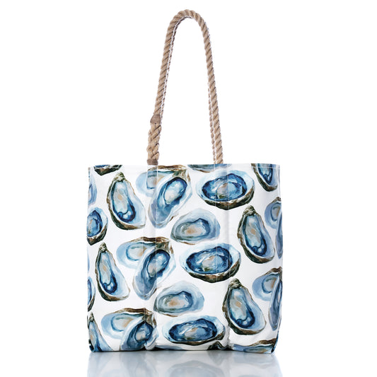 Introducing the Watercolor Oyster Medium Tote by Sea Bags—a white tote adorned with a blue and green oyster shell pattern evocative of watercolor artistry. Crafted from recycled sail cloth, this coastal beach tote is finished with two thick twisted rope handles, and is displayed here against a plain white background. by Sea Bags