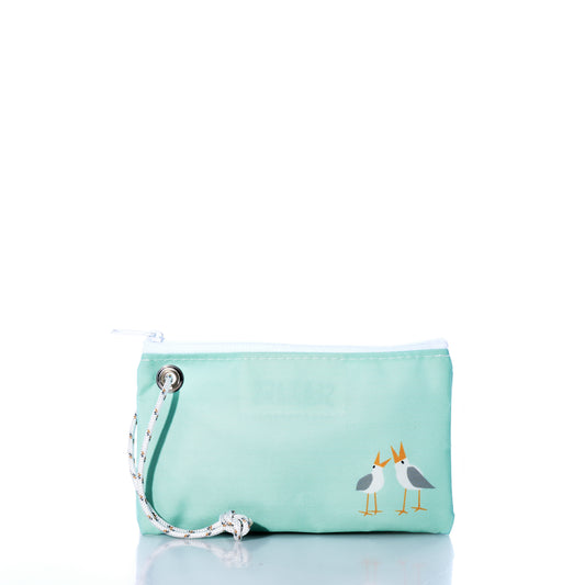 The Wharf Gulls Wristlet by Sea Bags is a light blue zippered pouch made from recycled sail cloth, featuring a white string loop and Kate Nelligan’s illustration of two sea gulls standing side by side in the lower right corner—a charming accessory perfect for carrying your everyday essentials. by Sea Bags