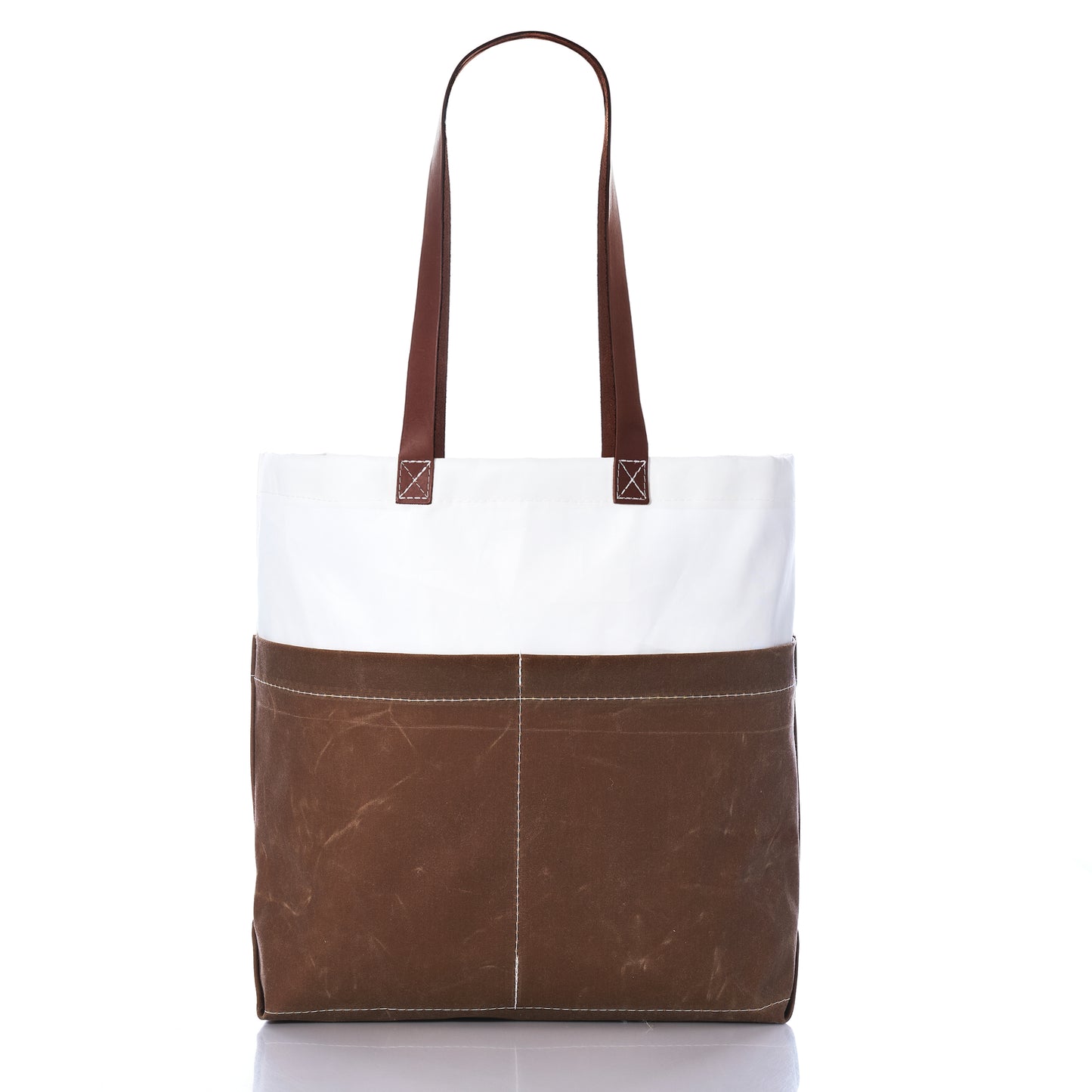 The Tan Chebeague Market Tote by Sea Bags features brown leather straps, a white upper section crafted from recycled sails, and a tan lower section made from durable waxed canvas with convenient external pockets, shown on a white background. by Sea Bags