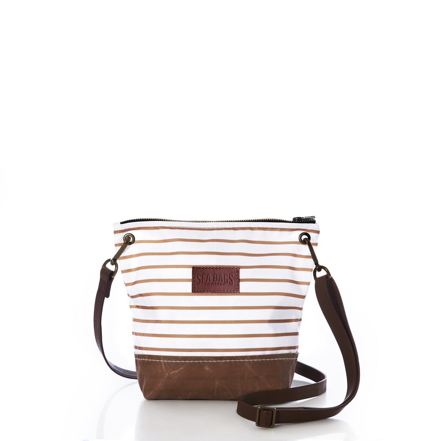 Sea Bags Tan Chebeague Stripe Crossbody, crafted from recycled sailcloth in brown and white stripes, features a zippered top closure, a dark brown leather shoulder strap, and a durable brown base. Displayed on a white background. by Sea Bags