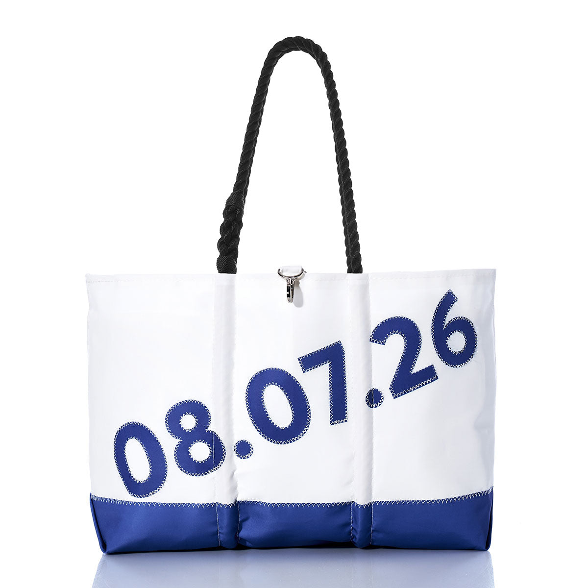 Sea Bags’ Custom Date Ogunquit Beach Tote is a white and blue personalized tote bag with a black rope handle, made from recycled sailcloth and decorated with large numbers 08.07.26 printed diagonally across the front—an ideal way to commemorate your special date at Ogunquit Beach. by Sea Bags