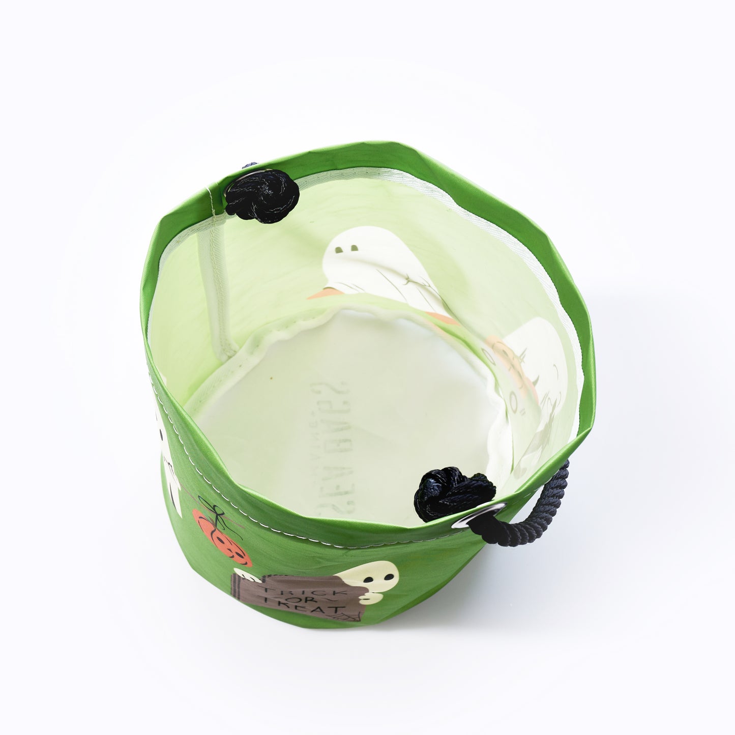 The Sea Bags Little Ghosts Bucket Bag features a green, Halloween-themed design with black handles and playful ghost, spider, and pumpkin accents—all crafted in a recycled sailcloth-inspired style—making it a festive and eco-friendly alternative to traditional trick-or-treat bags. by Sea Bags