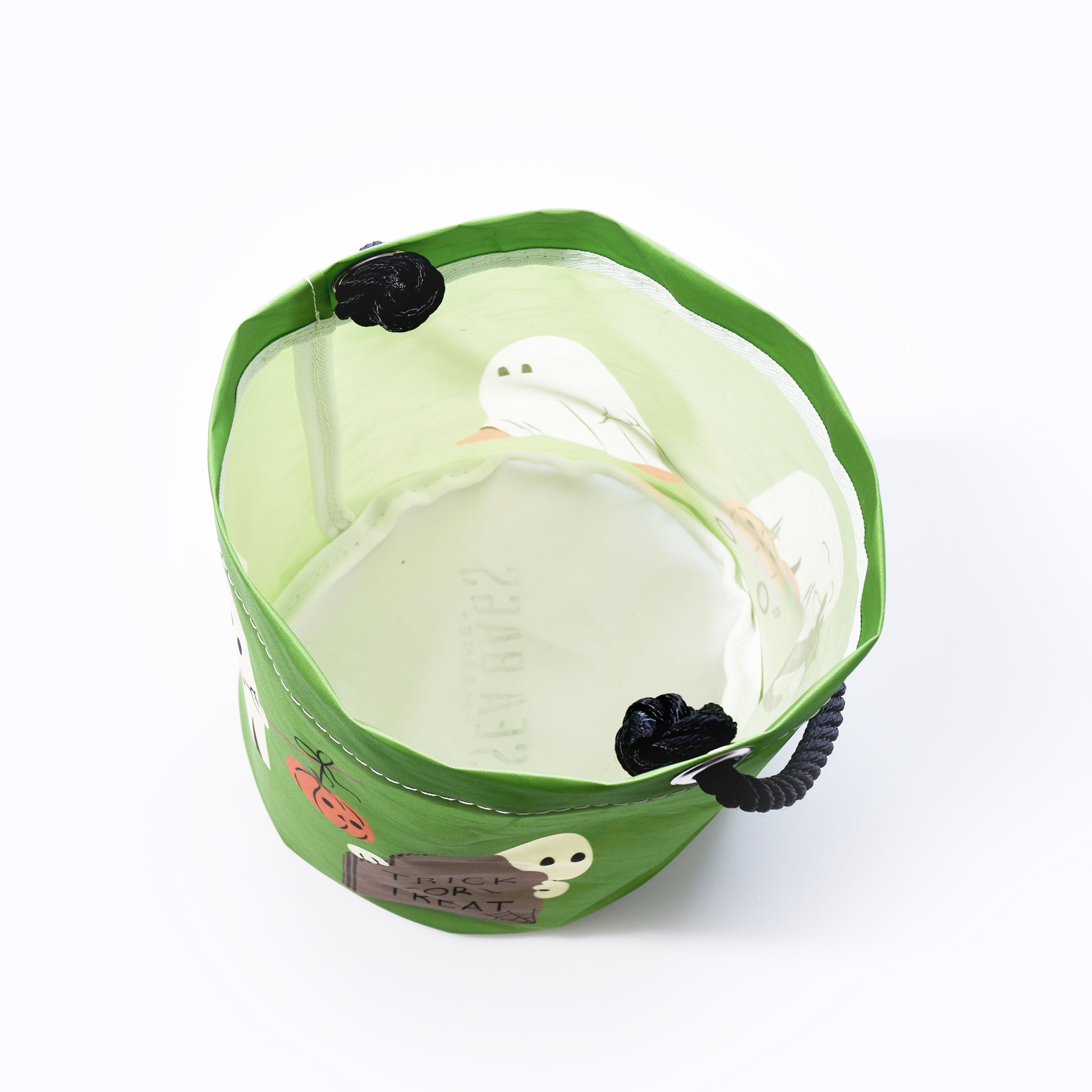 The Sea Bags Little Ghosts Bucket Bag features a green, Halloween-themed design with black handles and playful ghost, spider, and pumpkin accents—all crafted in a recycled sailcloth-inspired style—making it a festive and eco-friendly alternative to traditional trick-or-treat bags. by Sea Bags