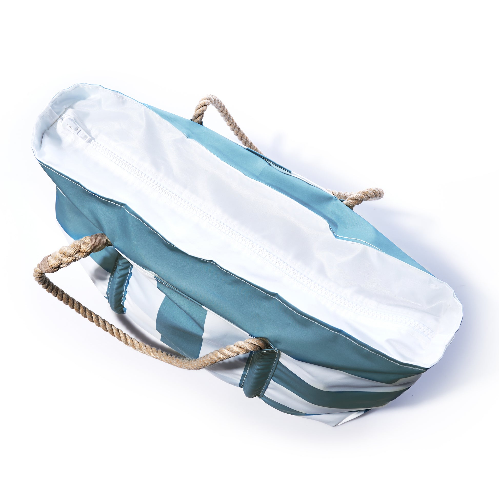 A Sea Bags Denim Blue Trolley Sleeve Travel Pier Tote, featuring blue and white stripes, rope handles, a white zipper, and a convenient trolley sleeve, is pictured from above on a white background. by Sea Bags