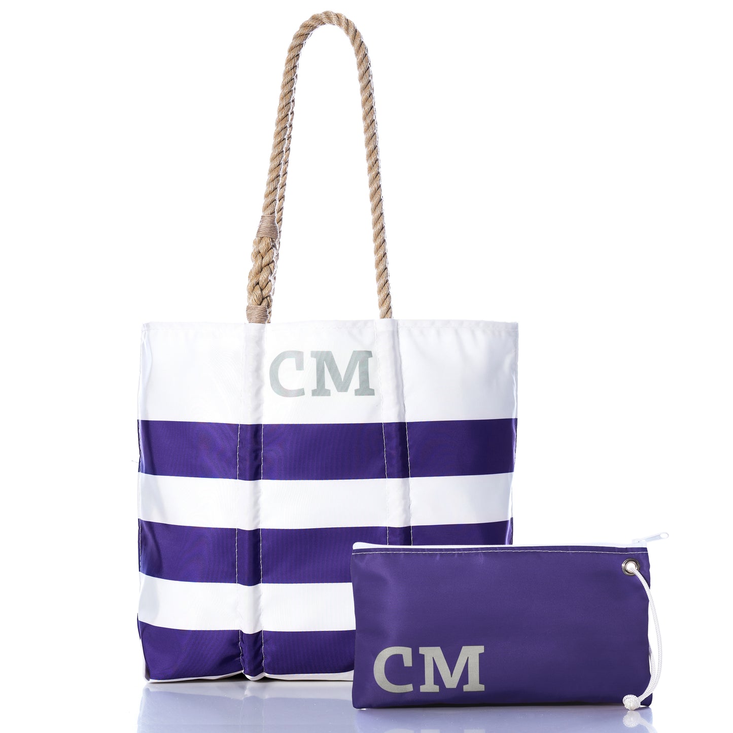 Sea Bags’ Custom Monogram Breton Stripe Medium Tote  Large Wristlet Bundle features a white and purple medium tote with rope handles and CM initials, crafted from recycled sailcloth for sustainability, paired with a matching personalized large wristlet showcasing the same distinctive CM monogram.