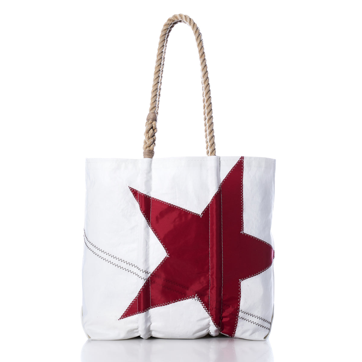 The Sea Bags Red Star Medium Tote features a bold red star design on white canvas with sturdy rope handles, handcrafted in the iconic Sea Bags style. Inspired by the Anniversary Archive Collection, this tote is both practical and distinctive, shown here photographed against a white background.