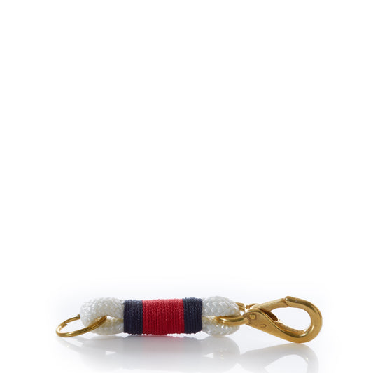Fishermans Rope Keychain-White/Red by Custom Cordage / DBA Maine Rope Mats, featuring a gold lobster clasp and keyring with a white yacht braid rope section wrapped in red and navy thread, hand made in Maine and shown against a white background. by Sea Bags