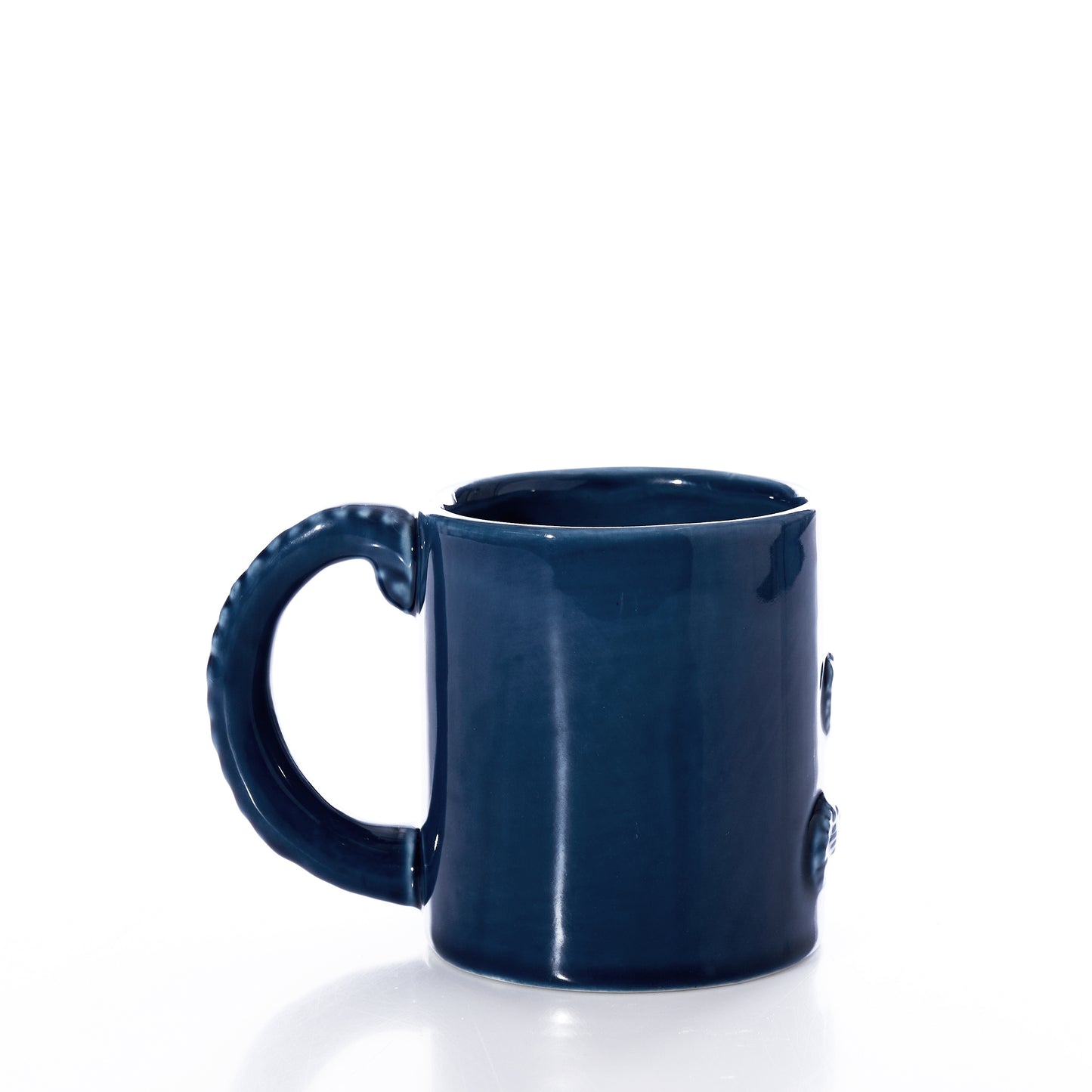 The Blue Octopus Mug by Batela USA Inc is a glossy-finished, dark blue ceramic mug with a rounded handle, displayed on a white background. Its deep, rich shade captures the mystery of the ocean. by Sea Bags