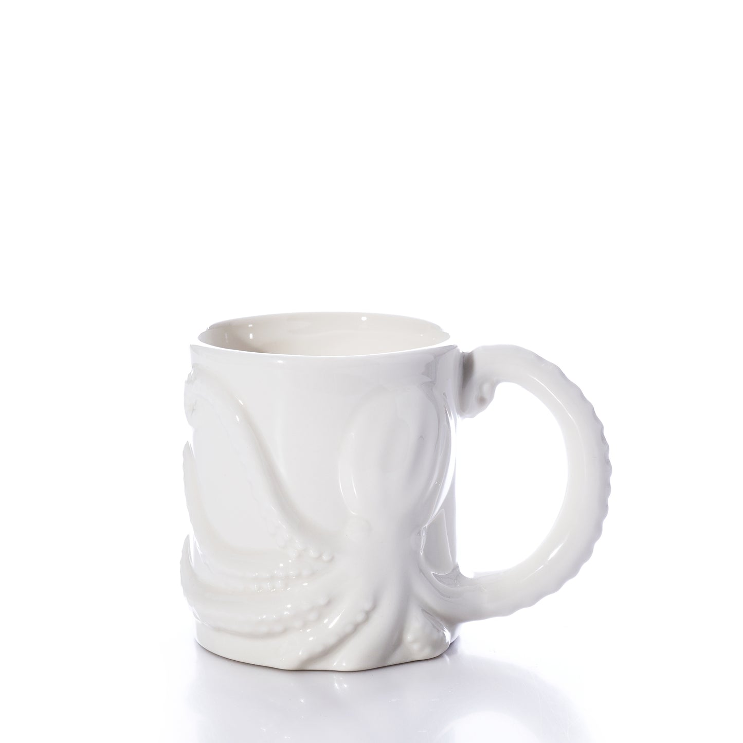 The White Octopus Mug by Batela USA Inc is a white ceramic mug with a raised octopus design, featuring one tentacle as the handle, and is shown against a plain white background. by Sea Bags
