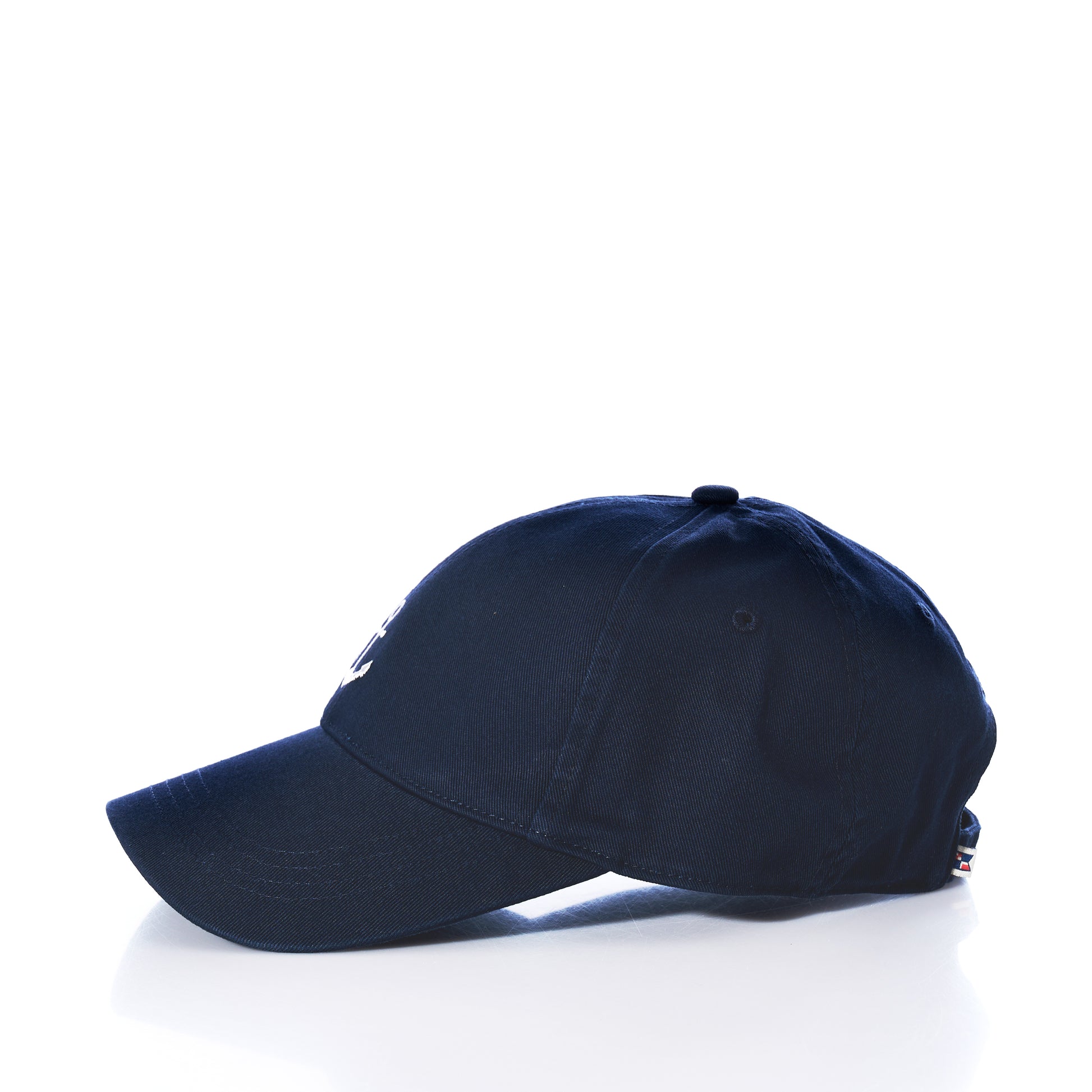 The Anchor Baseball Hat - Navy is displayed in profile against a white background, showcasing its slightly curved brim for sun protection and adjustable strap at the back.