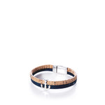 The Classic Cork Bracelet Anchor on Navy by Elisabetta Studio features a Portuguese cork band with a brown base, accented by a navy strip, an antique silver anchor charm, and a nickel-free magnetic clasp, displayed on a white background. by Sea Bags
