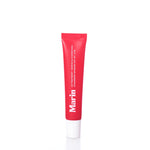 A red tube labeled Marin Skincare stands upright on a white surface. The text indicates it is the Marin Lip Treatment - Strawberry Rhubarb in a plastic container with a white cap, specially formulated with Marine Glycoproteins for enhanced lip hydration. by Sea Bags