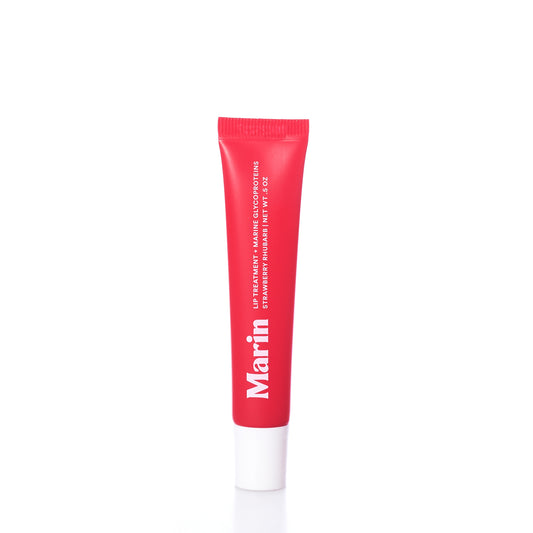 A red tube labeled Marin Skincare stands upright on a white surface. The text indicates it is the Marin Lip Treatment - Strawberry Rhubarb in a plastic container with a white cap, specially formulated with Marine Glycoproteins for enhanced lip hydration. by Sea Bags