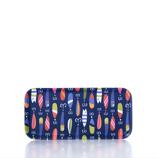 The Trays4Us Kate Nelligan Lures Tray is a rectangular blue tray adorned with a vibrant pattern of stylized fish, hooks, and bobbers. Crafted from Scandinavian birch and made in Finland, the tray is shown against a white background with a reflective surface below, showcasing its colorful Kate Nelligan Lures design. by Sea Bags