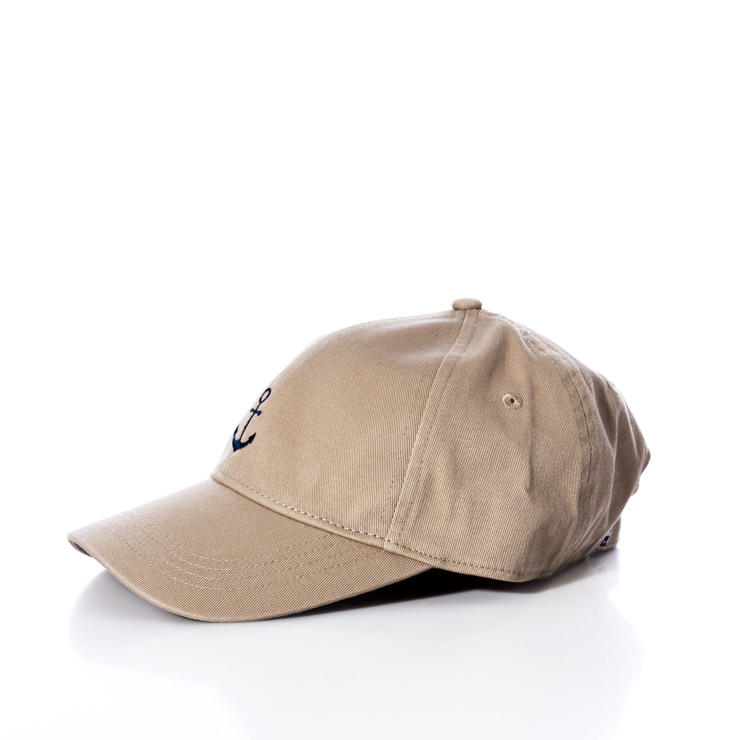 The Batela USA Inc Anchor Baseball Hat - Beige is a stylish sun-protective beige hat, featuring a small navy blue embroidered anchor on the front and showcased against a white background. by Sea Bags