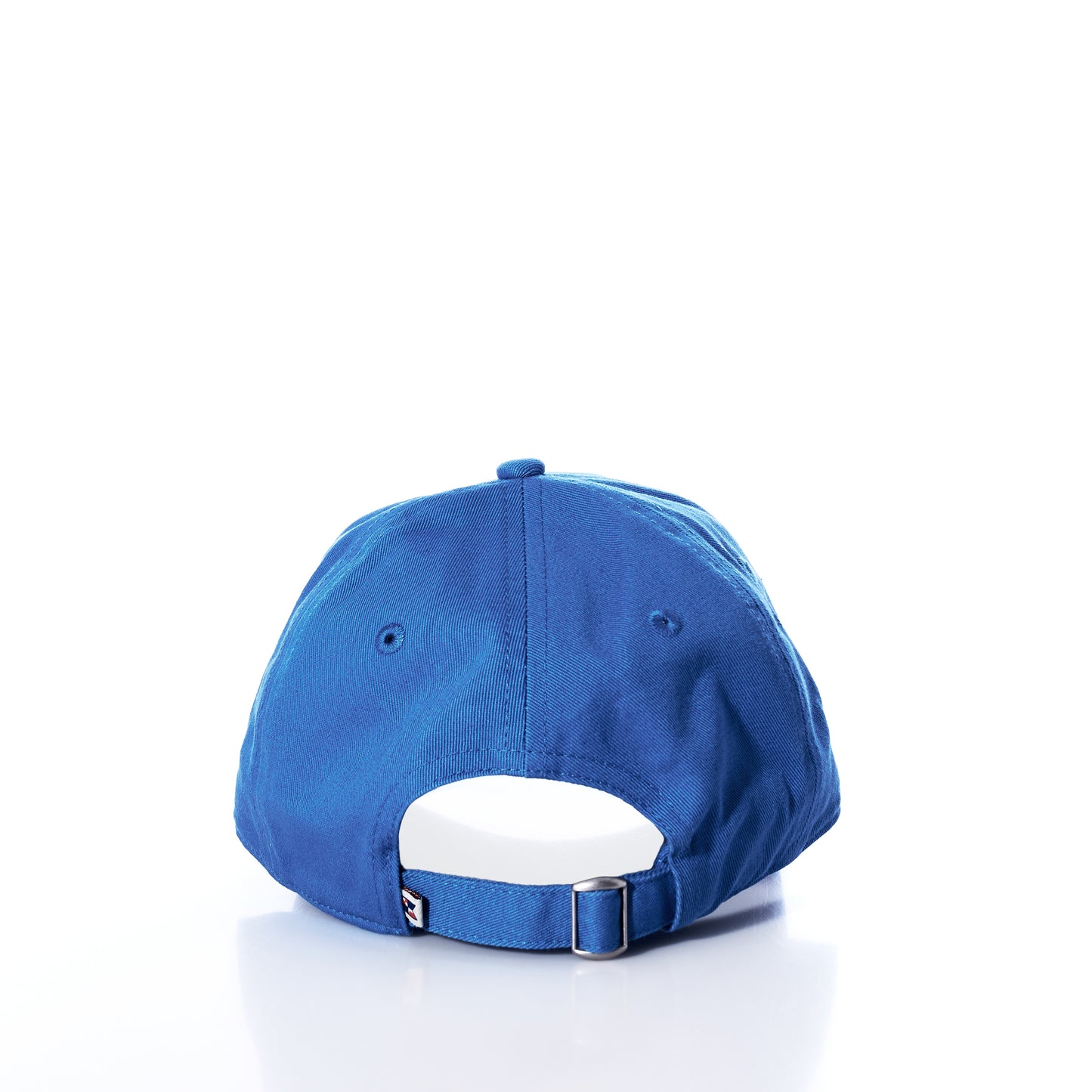 The Anchor Baseball Hat - High Tide by Batela USA Inc is shown from the back, highlighting its adjustable strap and metal buckle for a customizable fit. An embroidered anchor detail adds a nautical touch to this blue hat, which is perfect for sun protection and displayed on a white background. by Sea Bags
