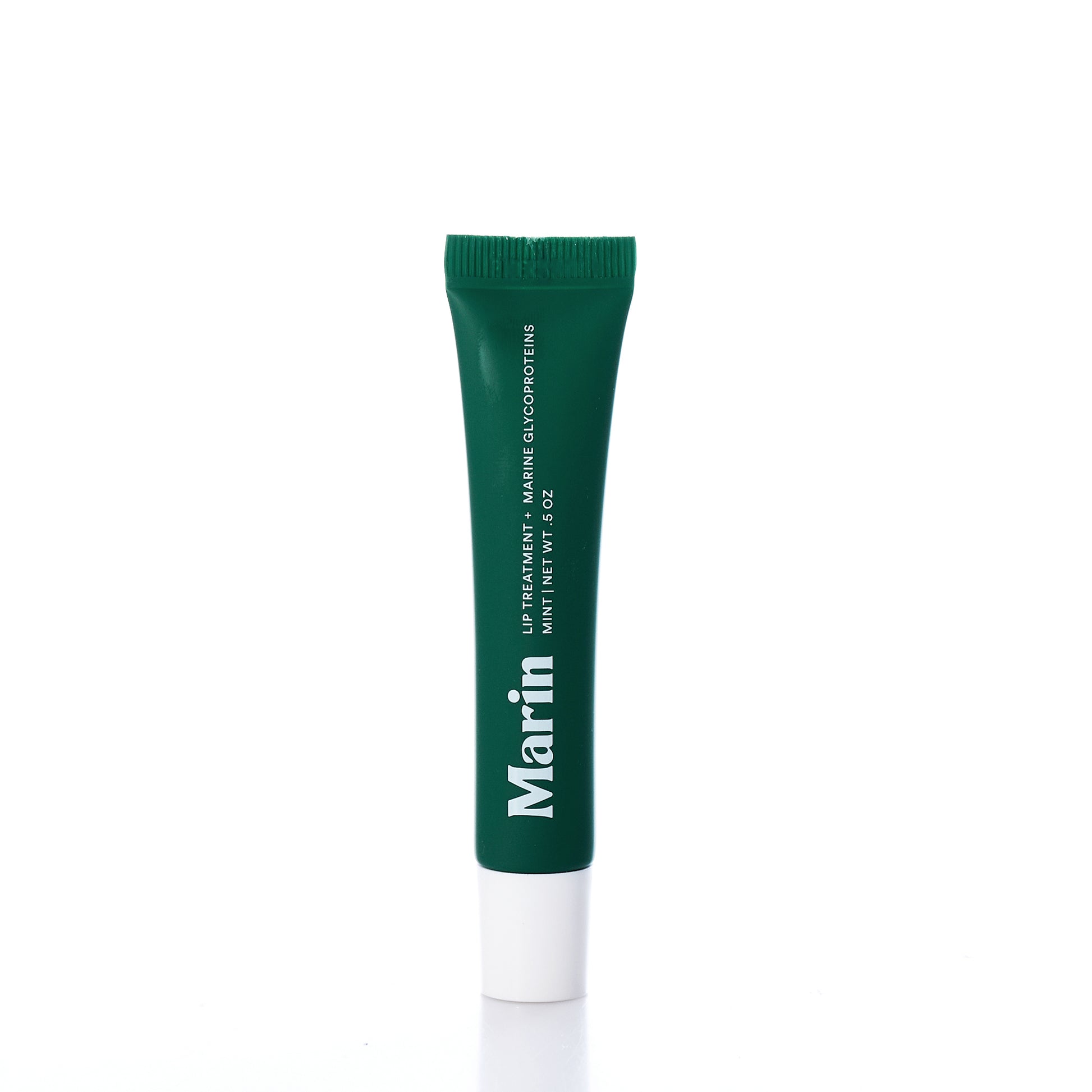 A green and white tube labeled Marin Skincare stands upright against a white background. The text reads Marin Lip Treatment - Mint, 11ml / 0.37oz, emphasizing its hydrating formula enriched with Marine Glycoproteins to leave lips smooth and refreshed. by Sea Bags