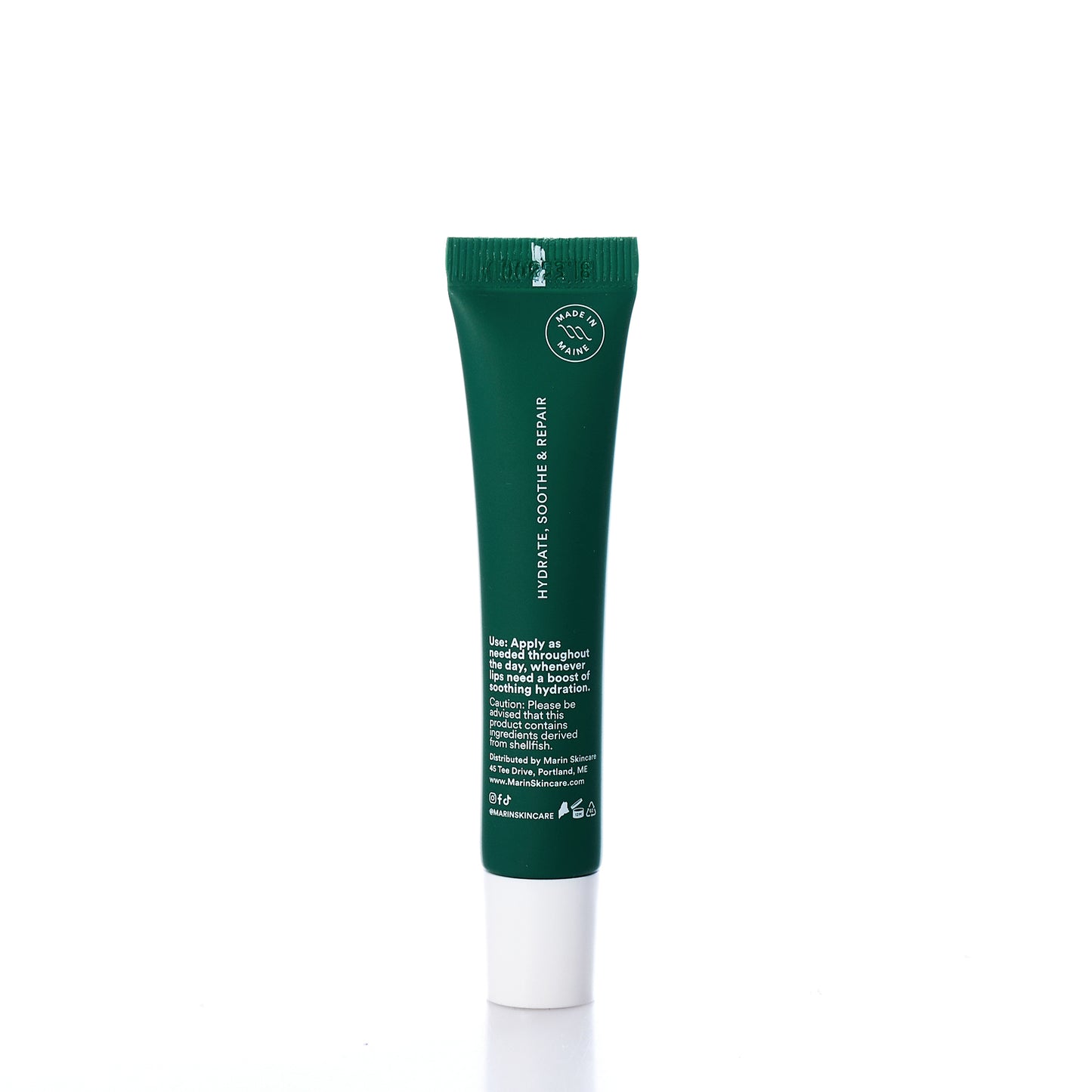 A green tube of Marin Skincares Marin Lip Treatment - Mint, infused with Marine Glycoproteins and featuring white text instructions, is shown standing upright on a white background. by Sea Bags
